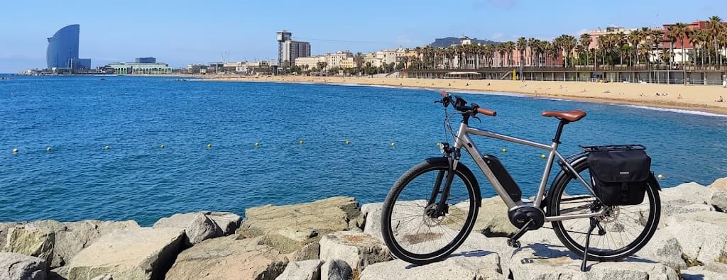 Barceloneta beach and the Barcelona seafront with a bicycle in the foreground