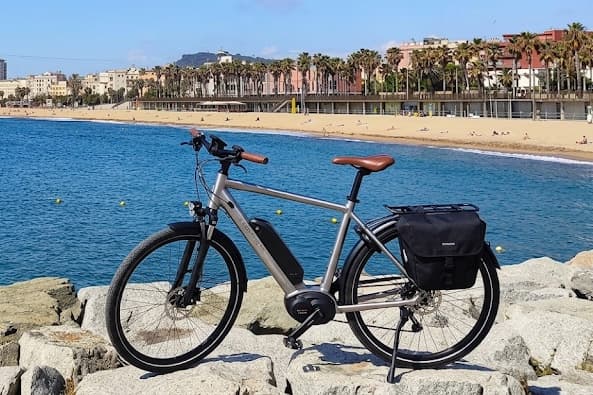 Barceloneta beach and the Barcelona seafront with a bicycle in the foreground