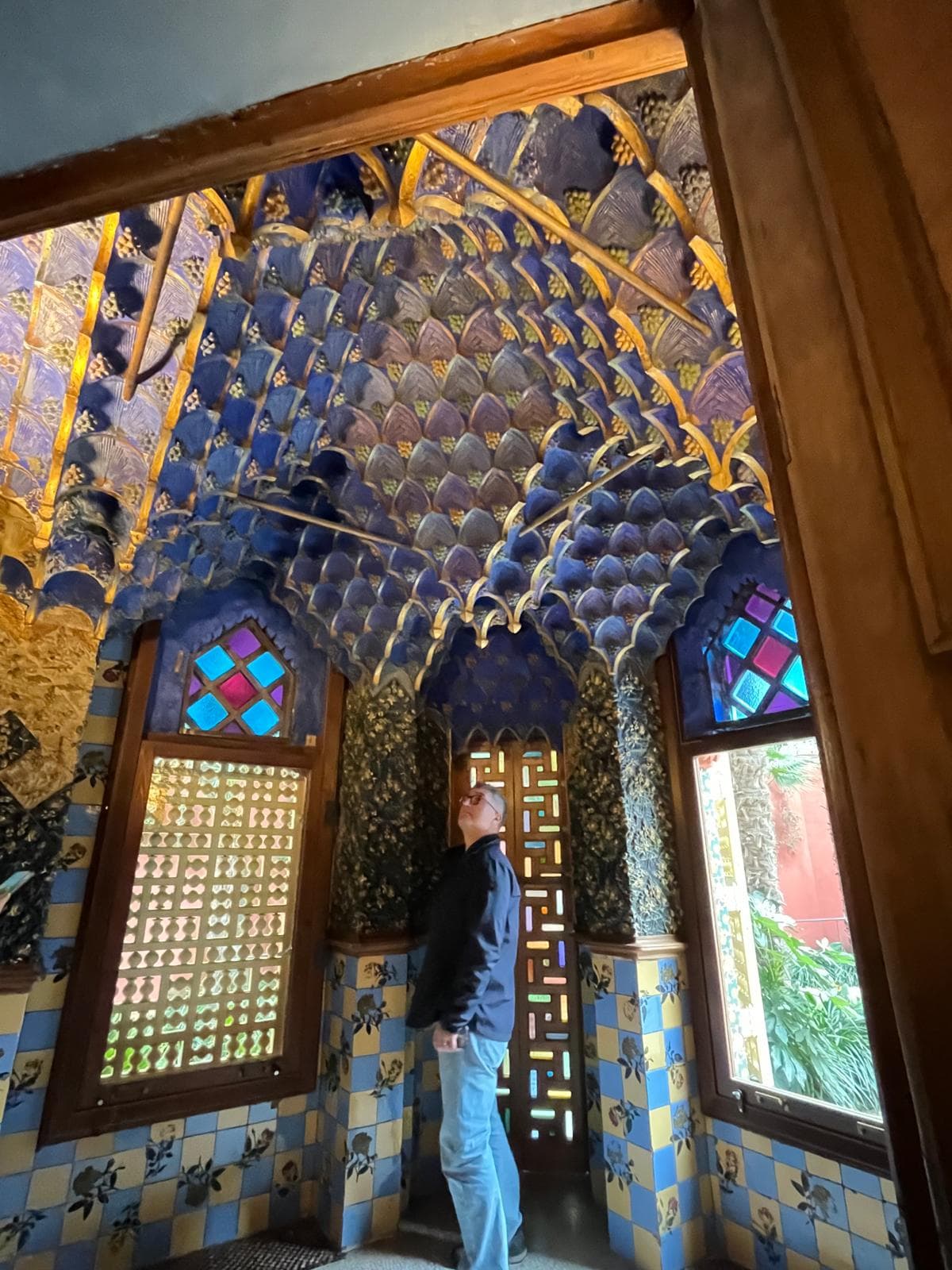 A richly tiled and painted interior room of Casa Vicens with stained-glass windows