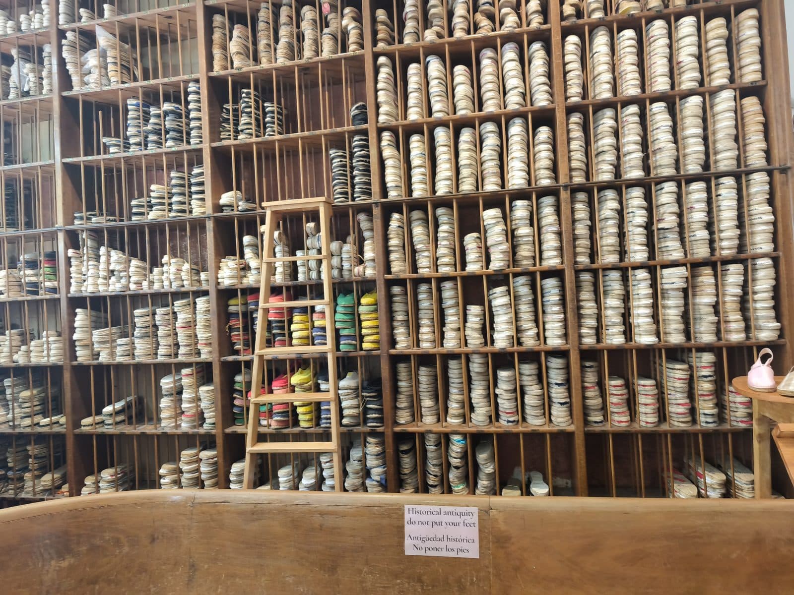 Shelves stacked with handmade coloured candles inside Cereria Subirà