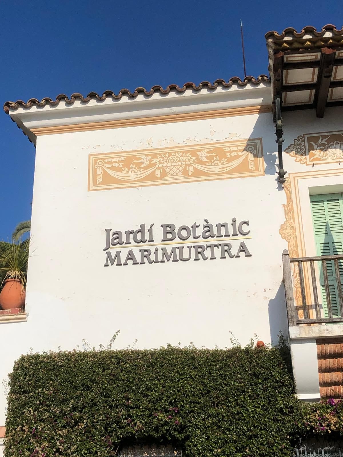 The whitewashed Marimurtra house with its painted “Jardí Botànic Marimurtra” sign