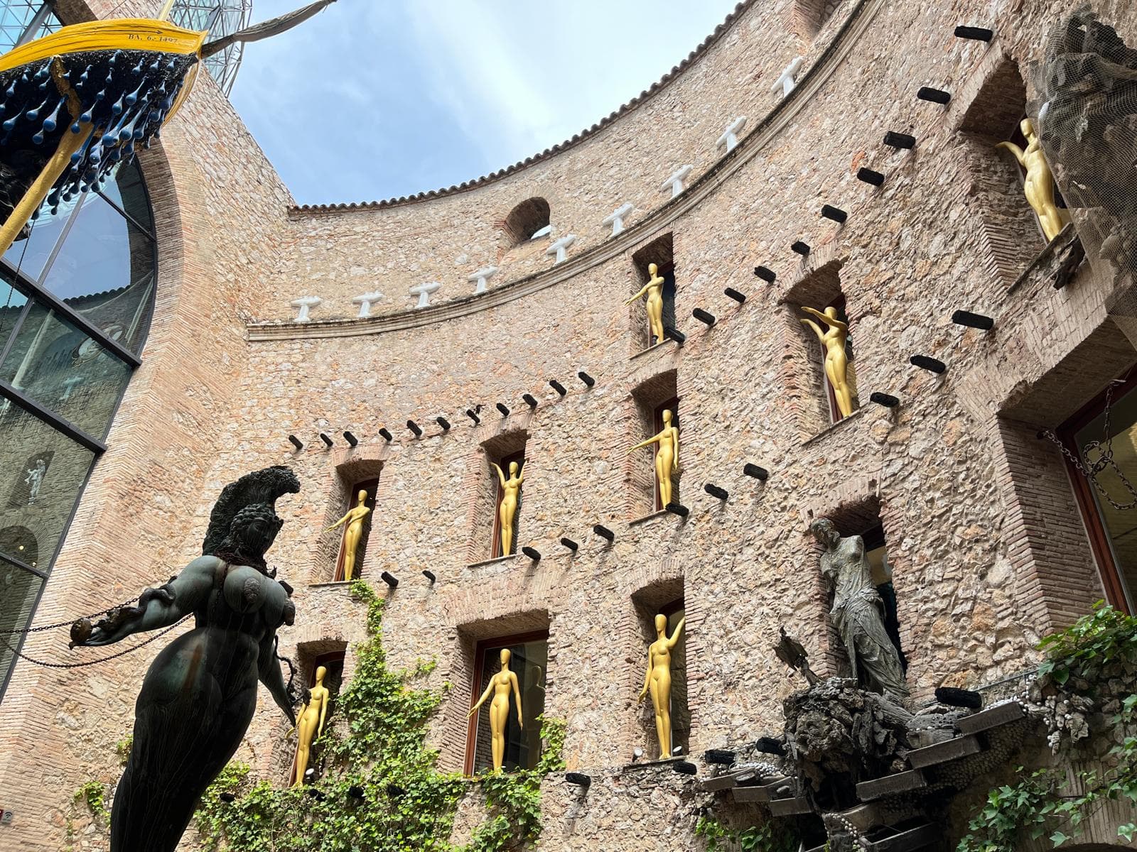 The glass geodesic dome and golden figures above the central courtyard of the Dalí Theatre-Museum