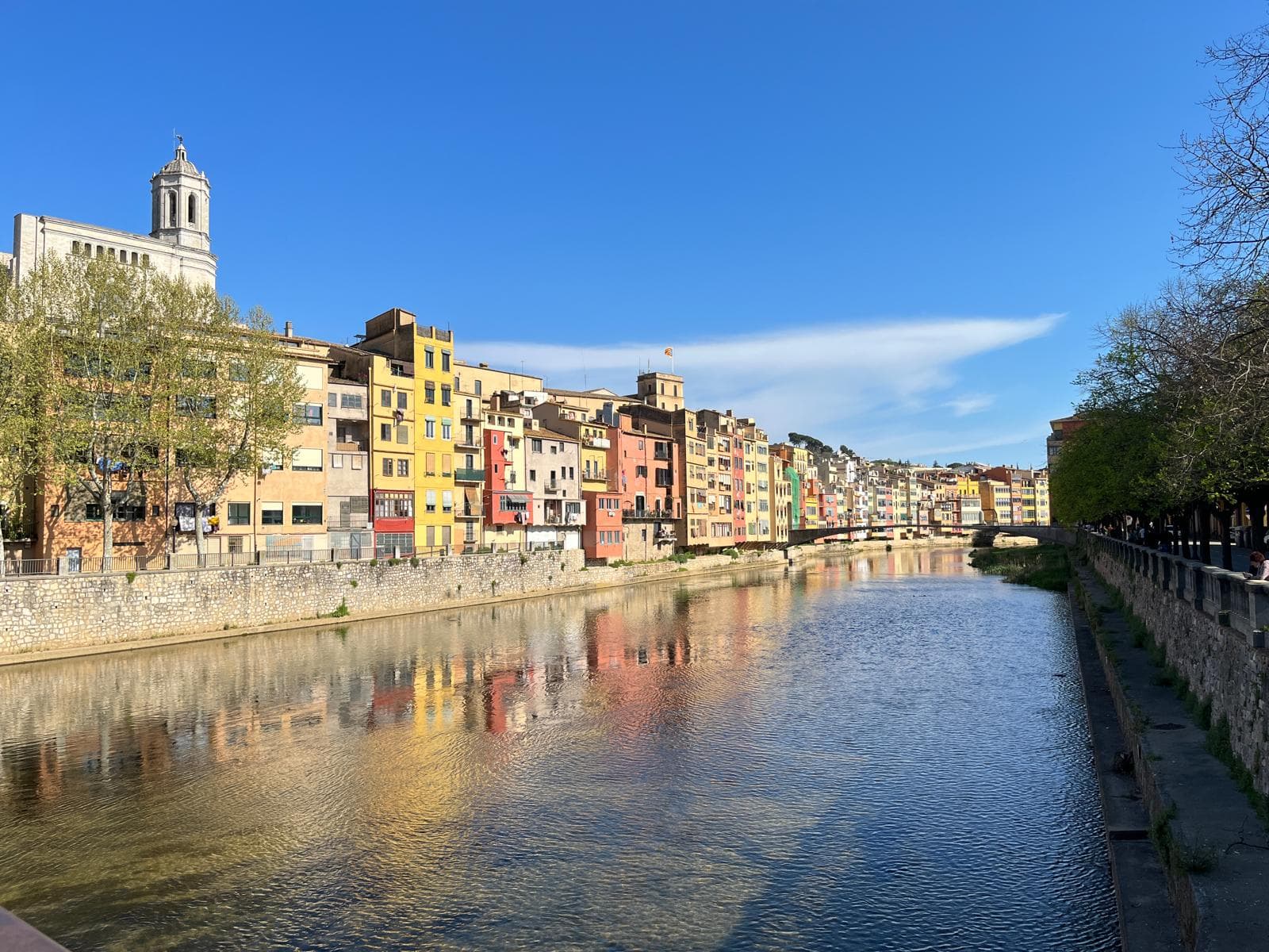 The coloured Cases de l’Onyar reflected in the river below Girona’s old town