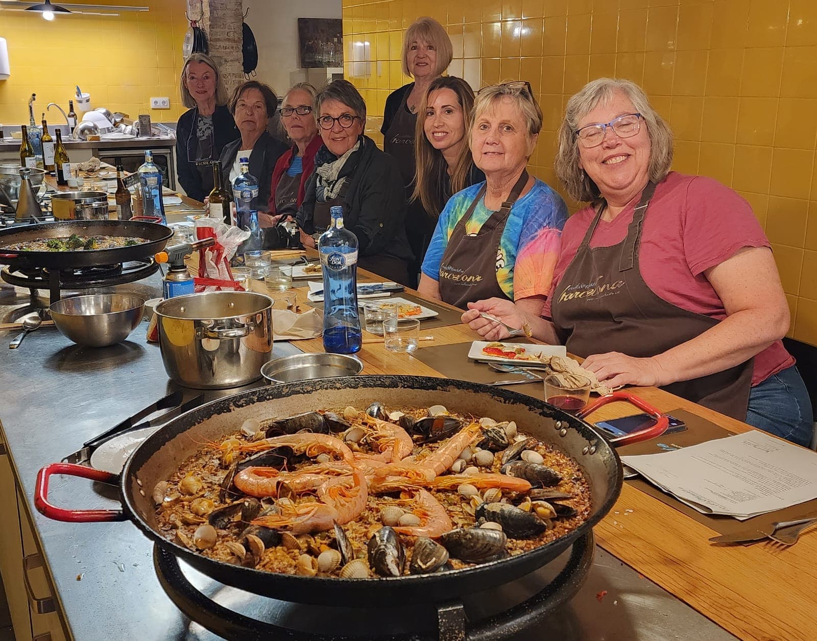 A hands-on paella cooking session around a large pan