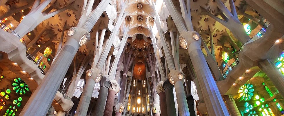 The stone canopy and stained-glass light of the Sagrada Família nave