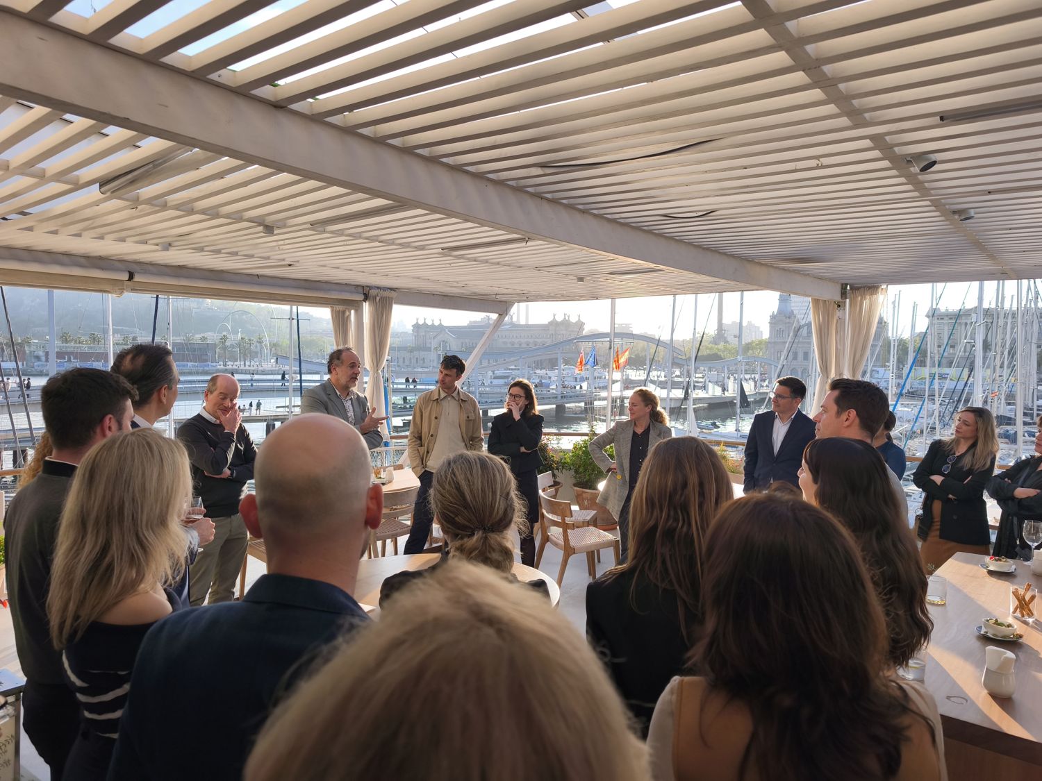A company gathering on a terrace overlooking the marina