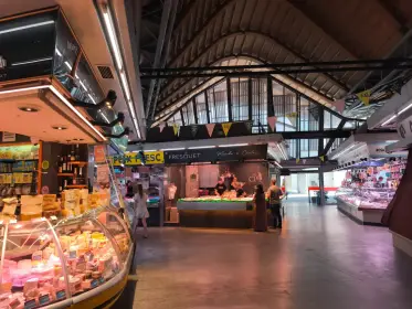 The wide market hall with its stalls under the iron roof