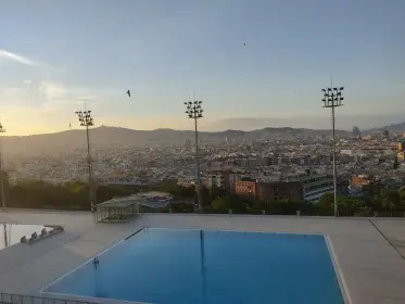The city at dusk seen from the terrace of the Montjuïc pool