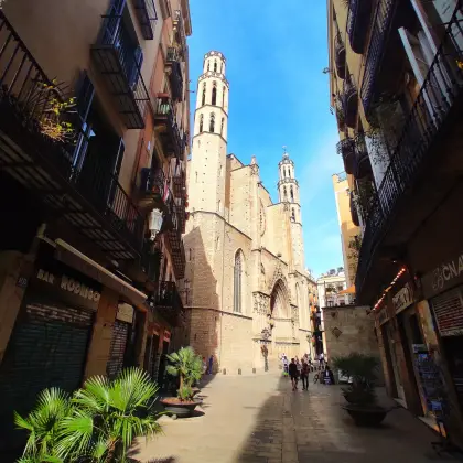 A narrow lane in El Born opening onto the basilica’s bell towers