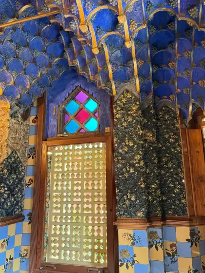 Una sala revestida de azulejos azules y dorados junto a su vidriera