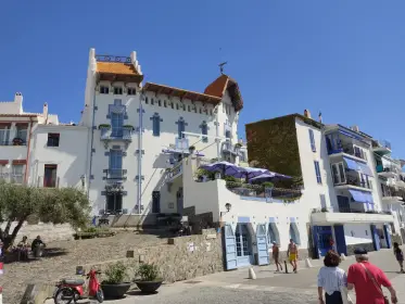 A blue-tiled seafront house above the promenade
