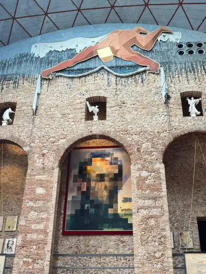 The courtyard wall painted with a swimming figure above the arcade