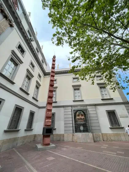 A tall totem sculpture rising in a courtyard of the museum complex