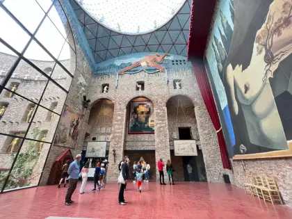 The stage hall under its glass dome, hung with monumental canvases