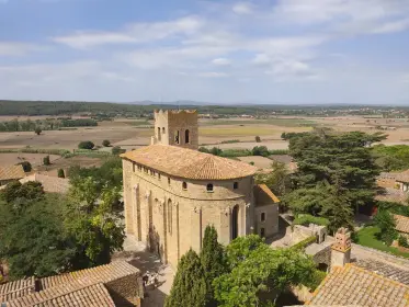 The village church and rooftops above the farmland of the plain