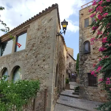 Bougainvillea and iron lanterns along a stepped lane