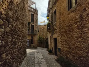 A narrow alley of worn stone between high walls