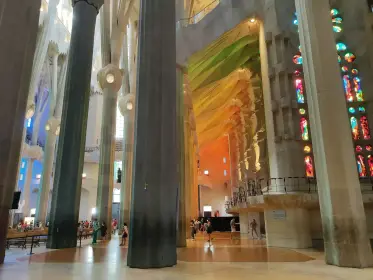 Coloured light from the windows falling across the pale columns