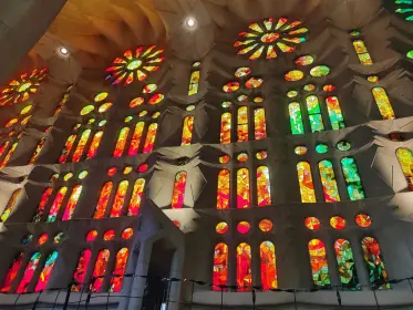 The stained glass of the western wall burning red and gold in the afternoon