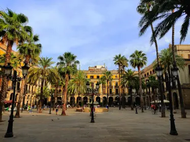 Palm trees, arcades and Gaudí’s lamp posts in Plaça Reial