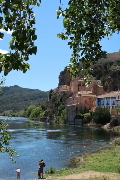 The river below the cliff village, walkers on the far bank