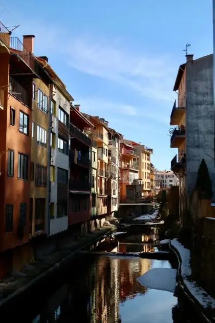 Tall coloured houses standing over the river channel